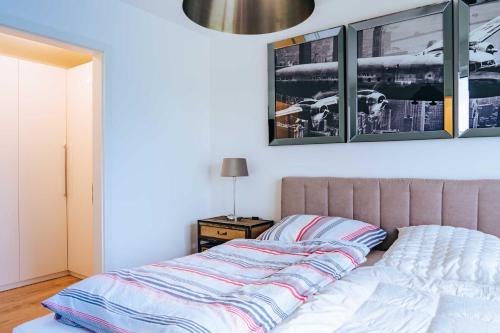 a bed in a bedroom with two pictures on the wall at Zweite Heimat Apartment 2 in Lohme