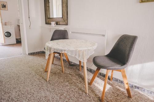two chairs and a table in a room at Villa Irbe in Jūrmala