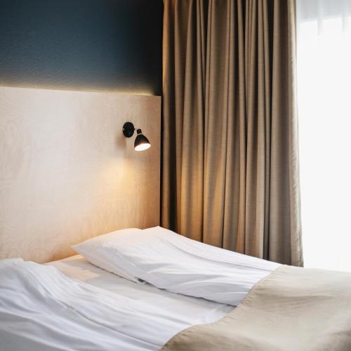 Postel nebo postele na pokoji v ubytování 62N Hotel - City Center