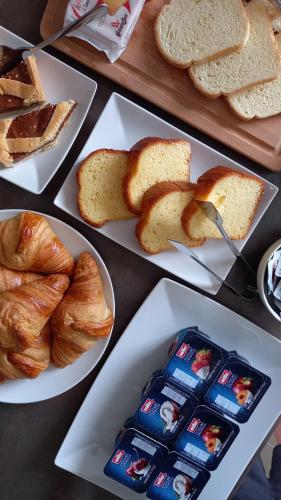 a table with three plates of bread and pastries at B&B casa73 in Cicerale
