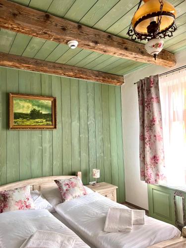 a bedroom with a bed with a green wall at Vila Liberta in Poprad