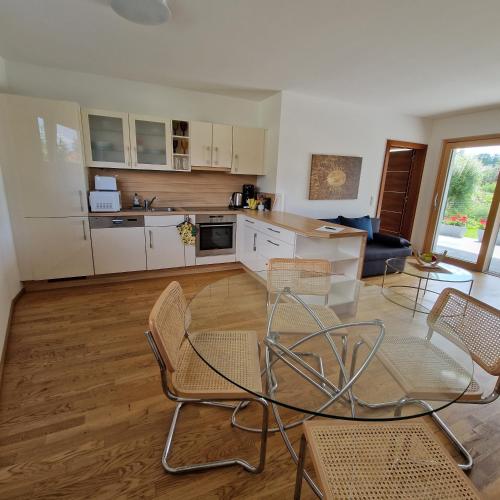 a kitchen with a table and chairs in a room at Comfy Plaza in Aurolzmünster