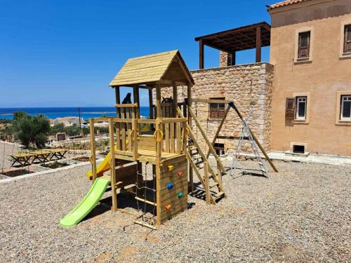 a wooden playground with a slide and a play structure at Harmony Seaview Villas In Elafonisos in Elafonisos
