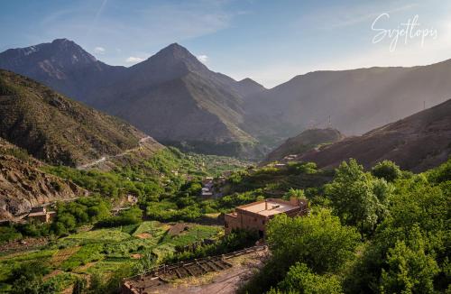 a view of a valley in the mountains at Toubkal Ecolodge in Imlil
