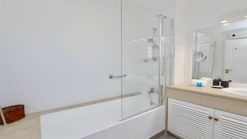 a bathroom with a shower and a sink at Vila Castro-Cleverdetails, Quiet area, private pool in Vilamoura