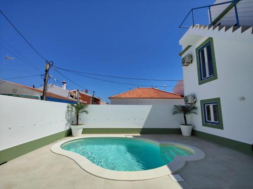 a swimming pool in the courtyard of a house at Corkoon - Duna Parque Resorts & Hotels in Vila Nova de Milfontes