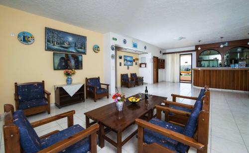 a living room with a wooden table and chairs at Hotel Eleni Anagros in Archangelos