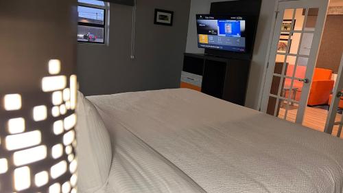 a bedroom with a bed and a flat screen tv at La Quinta Inn Lexington-Horse Park in Lexington