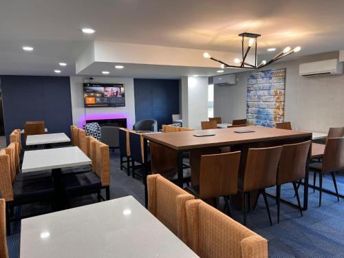 a dining room with a large table and chairs at La Quinta Inn Lexington-Horse Park in Lexington