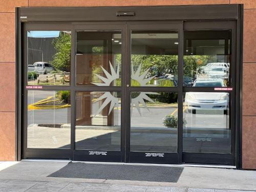 an entrance to a building with glass doors at La Quinta Inn Lexington-Horse Park in Lexington
