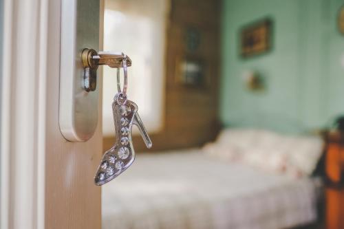 a key hanging from a door in a bedroom at Villa Irbe in Jūrmala
