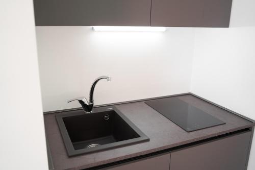 a kitchen counter with a sink in a kitchen at Toto e Peppino Luxury Rooms in Naples