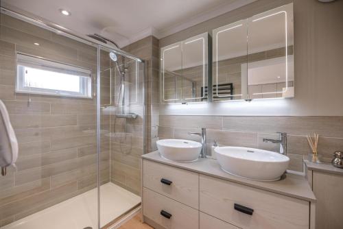 a bathroom with two sinks and a shower at Briargate, Aldeburgh in Aldeburgh