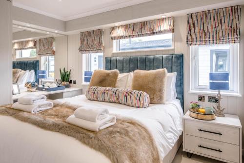 a bedroom with a large white bed with a furry blanket at Briargate, Aldeburgh in Aldeburgh