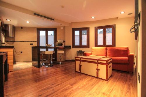 a living room with a couch and a table at Apartamentos Turísticos Aguas de Viznar in Víznar