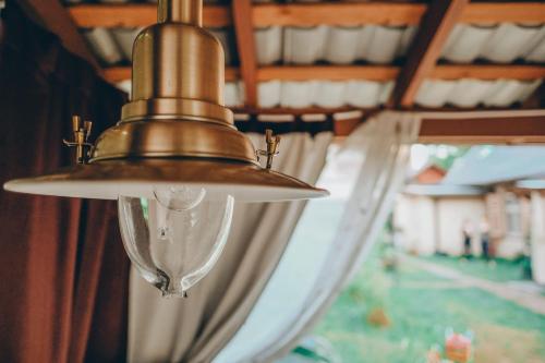 a brass light fixture hanging from a ceiling at Villa Irbe in Jūrmala