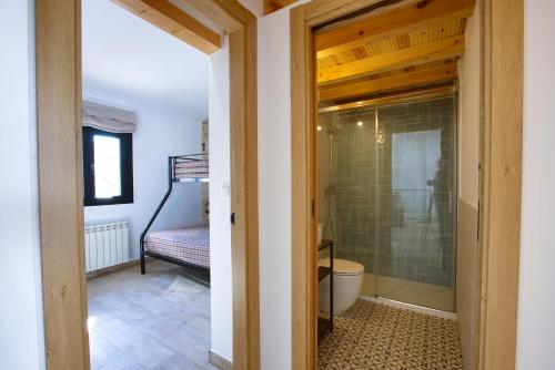 a bathroom with a shower and a toilet in a room at Cuencaloft El Patio de Enrique in Cuenca