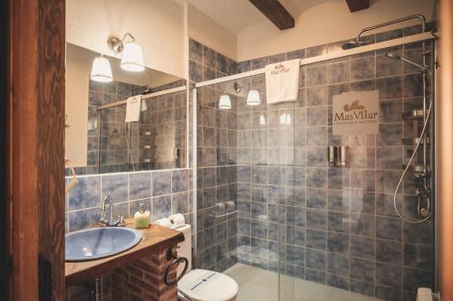 a bathroom with a sink and a toilet and a shower at Mas Vilar, relax, nature and slow Exclusive Only 6 rooms in Arbúcies
