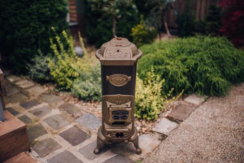 a clock sitting on the ground in a garden at Villa JKC in Brno