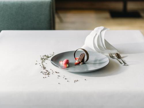 a plate with a pair of engagement rings on it at Das König Ludwig Inspiration SPA in Schwangau