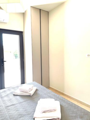 a room with a bed with two towels on it at Villa Pul in Risan