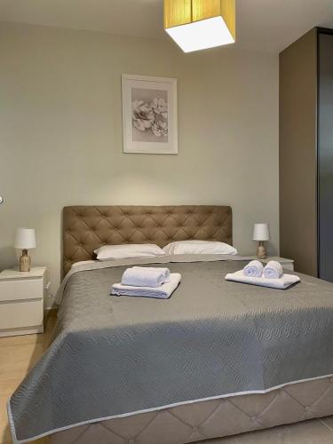 a bedroom with a large bed with two towels on it at Villa Pul in Risan