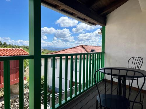 a balcony with a table and a view at A Parada House by Kev in Parada del Sil