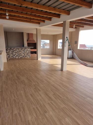 a large room with a wooden floor and a fireplace at CRUCITALIA suite x 4 in Crucita