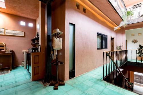 a hallway of a house with a hat on the wall at Boulenc Bed and Bread in Oaxaca City