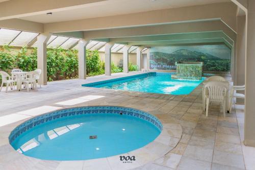 a swimming pool in a house with a patio at VOA Plazza Hotel in Águas de Lindóia