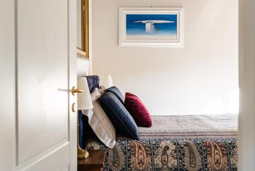 a bedroom with a bed with pillows on it at Gli specchi in Lucca
