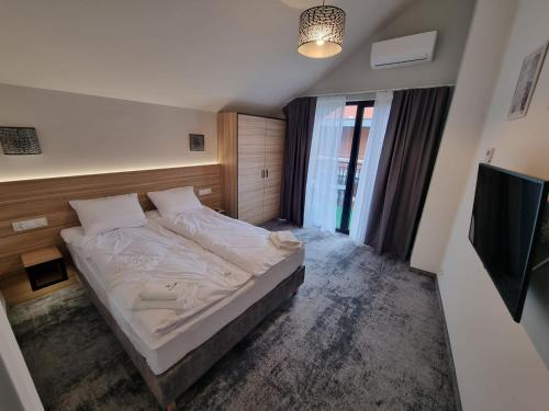Кровать или кровати в номере Domki Gold-Time Niechorze