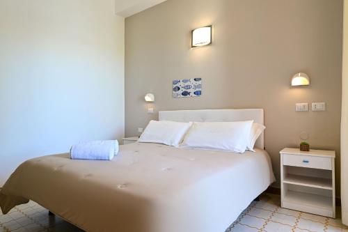 a bedroom with a large white bed with two pillows at Amadei Hotel Promenade in Pesaro