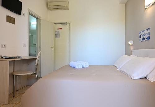 a bedroom with a bed with towels on it at Amadei Hotel Promenade in Pesaro