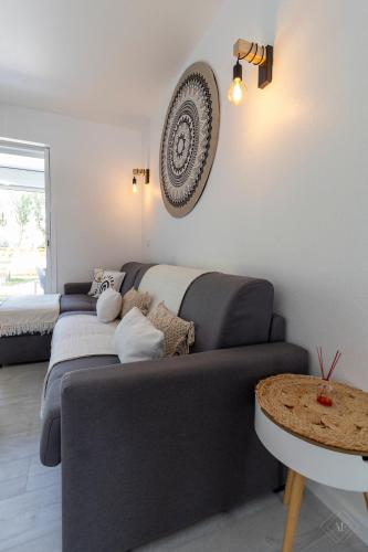 a living room with a couch and a table at Kaffa50 - Plage & 3Piscines - Anse Marcel in Anse Marcel 