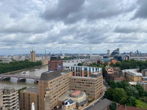 a view of a city with a river and buildings at Parliament House - Luxury Penthouse in London