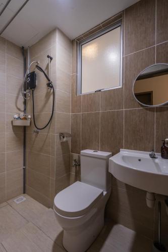 a bathroom with a toilet and a sink and a shower at Cozy 3-bedroom condo with pool 6 pax - Semarak in Kuala Lumpur