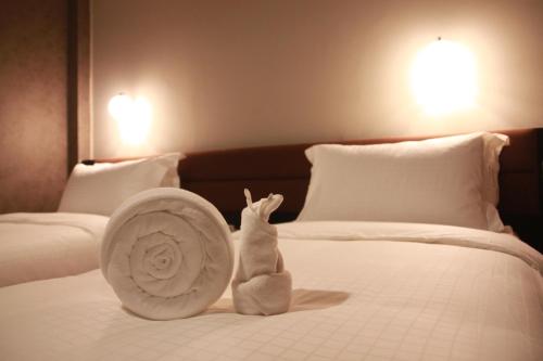 a stuffed bunny on a bed in a hotel room at C U Inn Bangkok in Bangkok