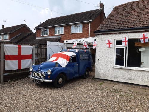 a blue truck parked in front of a house at Littleholme in Potter Heigham