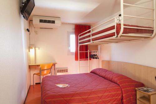 a bedroom with a bed and a bunk bed at Premiere Classe Evreux in Évreux