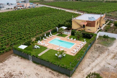 an aerial view of a house with a swimming pool in a field at Alle Vigne Affittacamere in Alcamo