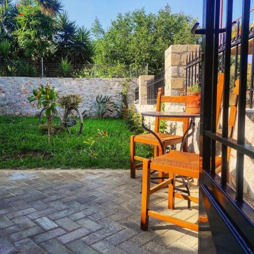 a wooden bench sitting outside of a house at Το Πατρικό - To Patriko Epidavros in Ancient Epidavros