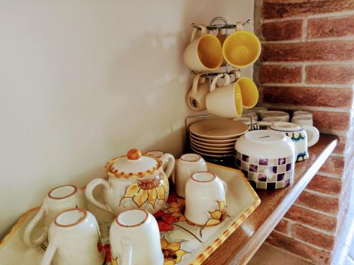 a shelf with a bunch of tea pots and pans at Casa rustica con terrazza e barbecue in Sessano Del Molise