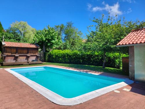 a swimming pool in the backyard of a house at Fogar de Breogán in Pontevedra