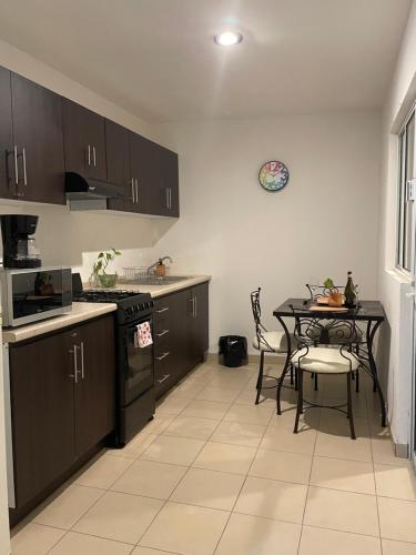 a kitchen with a table and a dining room at Departamento amueblado in San Luis Potosí
