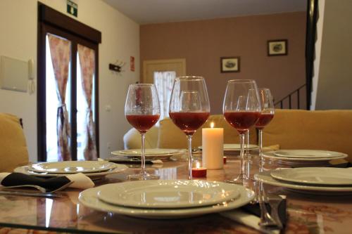 a table with wine glasses and plates on it at El Corralillo del Abuelo in La Lapa