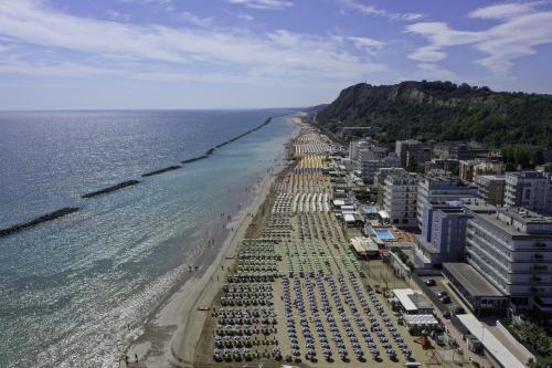 an aerial view of a beach with umbrellas at Amadei Hotel Promenade in Pesaro