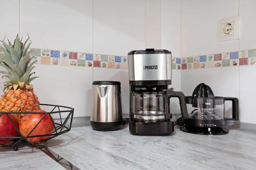 a coffee maker and a pineapple on a kitchen counter at Casita Amiga del Mar in Gran Tarajal