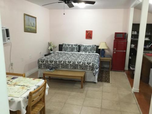a bedroom with a bed and a table and a bed sidx sidx sidx at Studio apartment at Historical House in Galveston