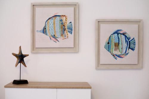 two framed pictures of fish on a white wall at Casa Relax in Gran Tarajal